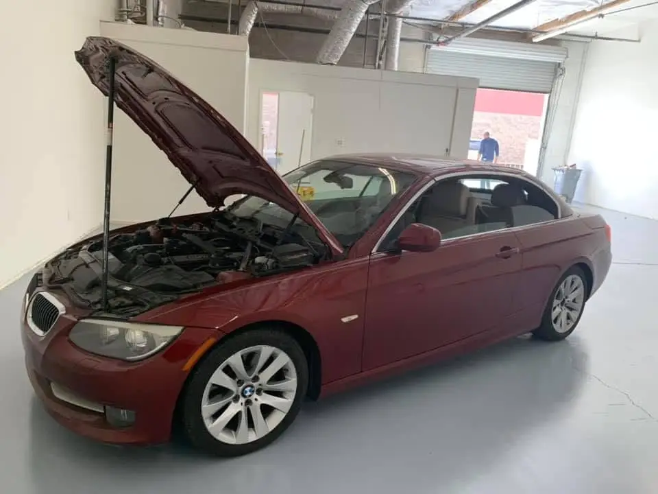 Technician performing engine repair on a BMW 3 Series at Valette Auto Repair in Chandler