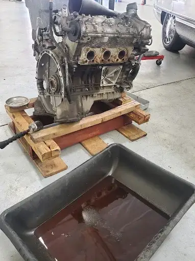 Engine rebuild with oil being drained during a mechanical overhaul in Chandler
